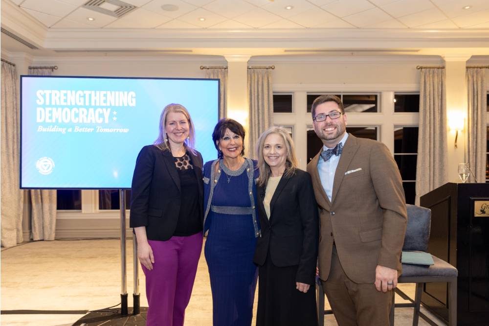 President Mantella standing with panelists Nicole Hemmer, Lisa Perhamus, and Kyle Kooyers